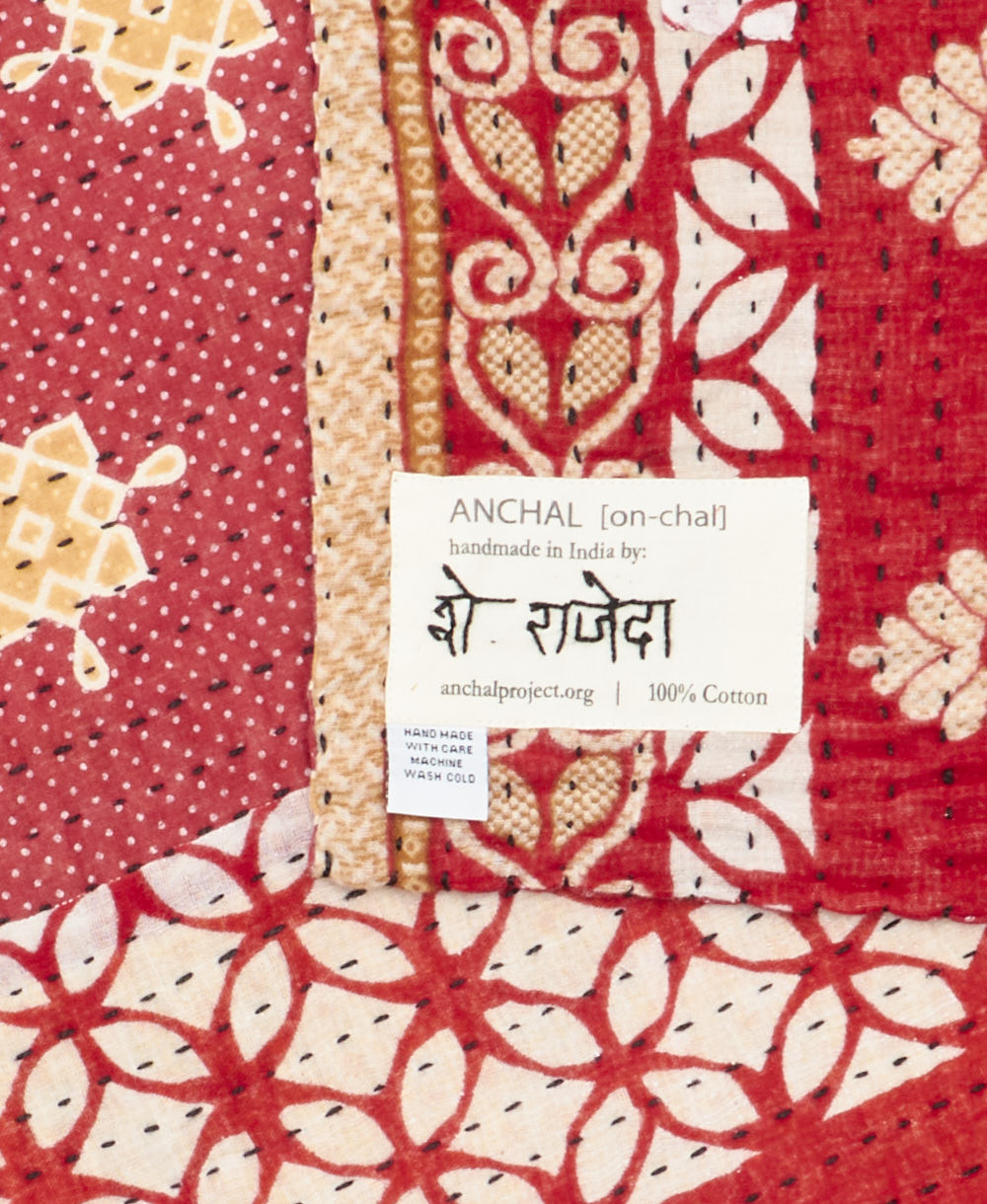 small kantha blanketwith signature of the maker on the tag