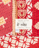 small kantha blanketwith signature of the maker on the tag