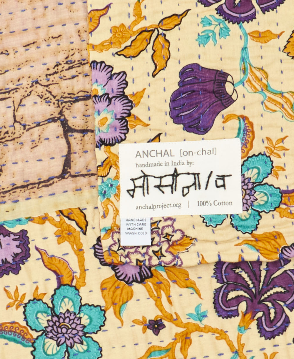 small kantha blanketwith signature of the maker on the tag