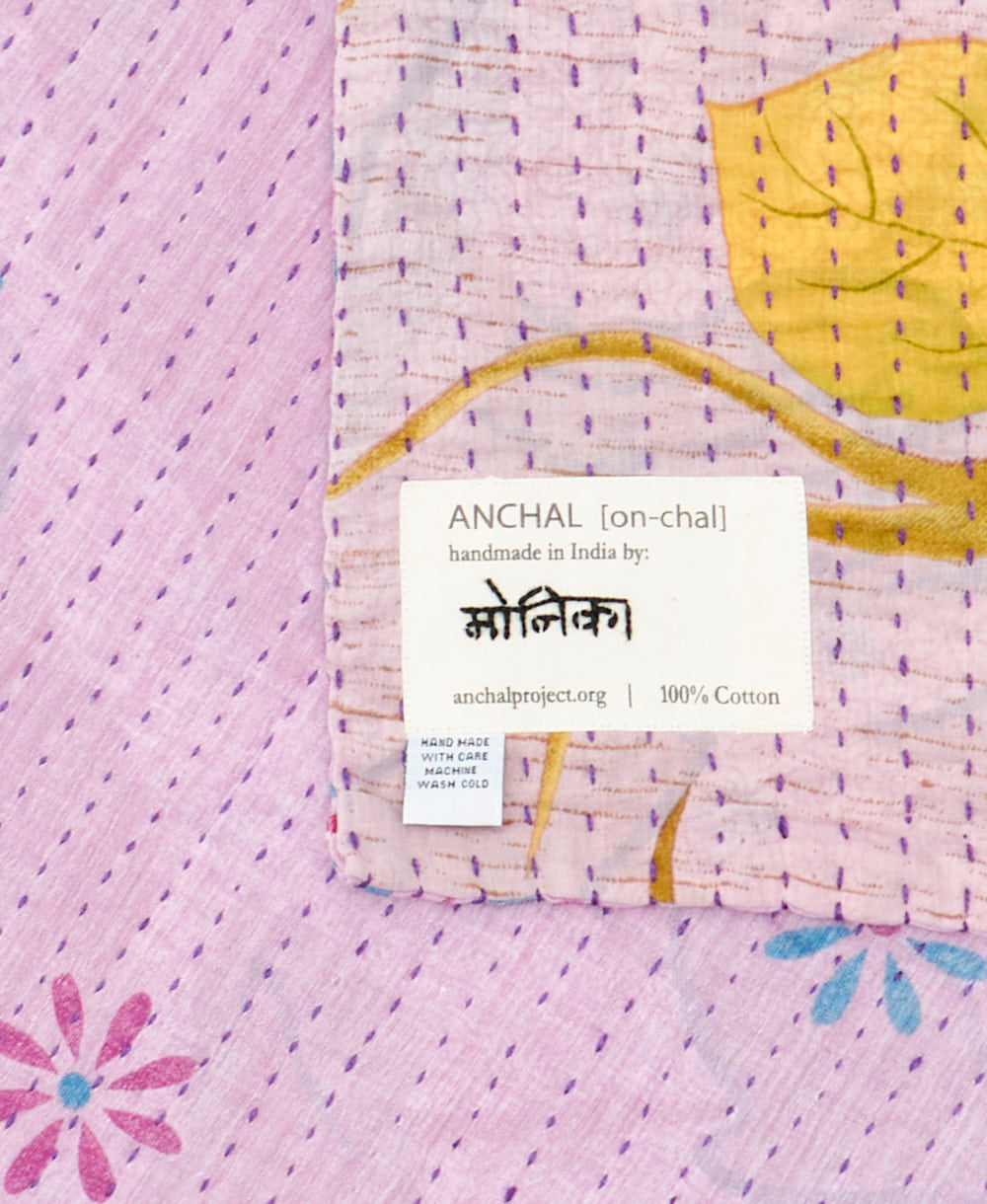 small kantha blanket with signature of the maker on the tag