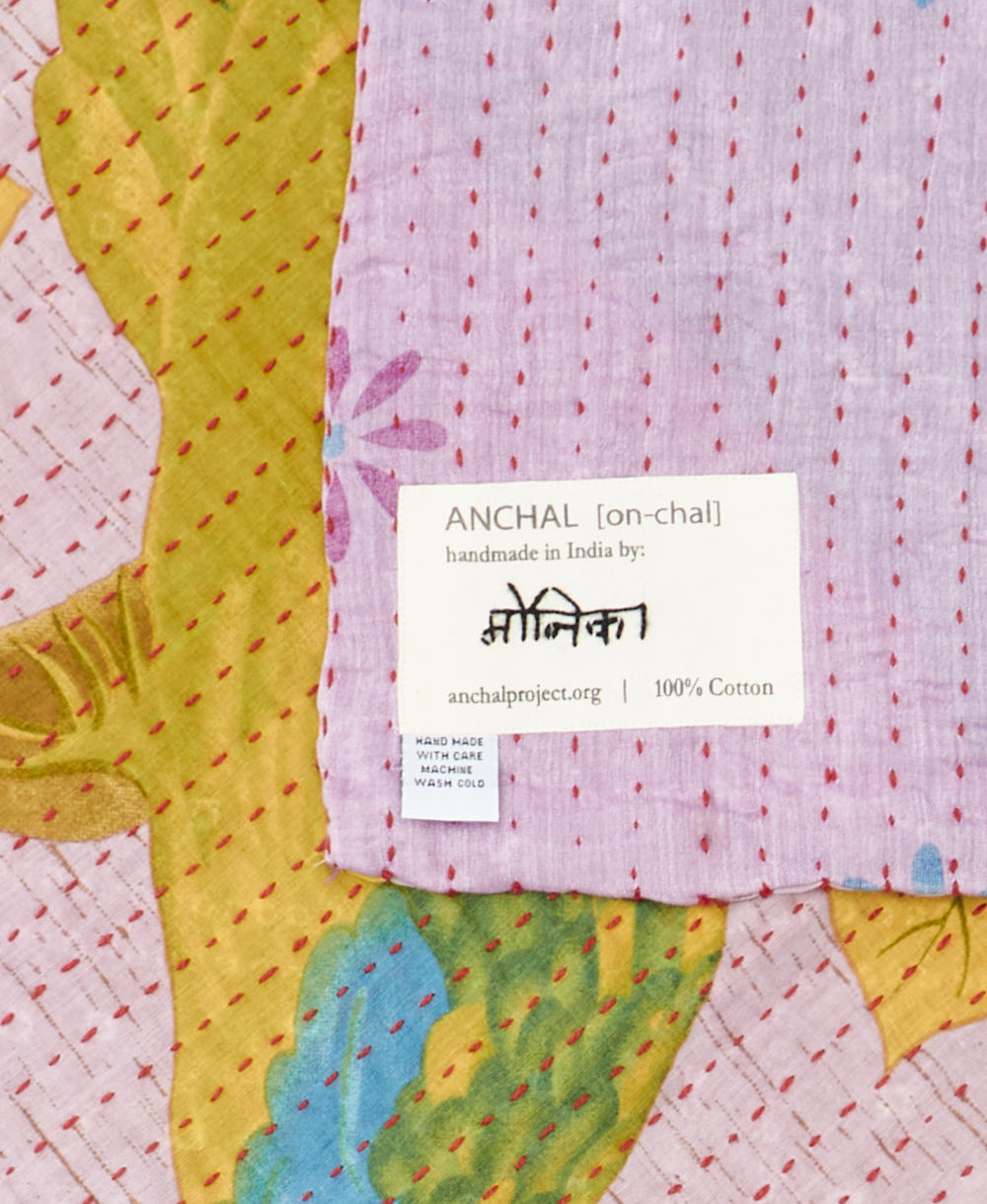 small kantha blanket with signature of the maker on the tag