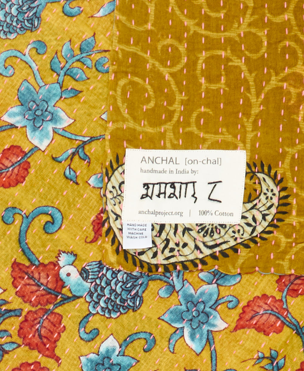 small kantha blanket with signature of the maker on the tag