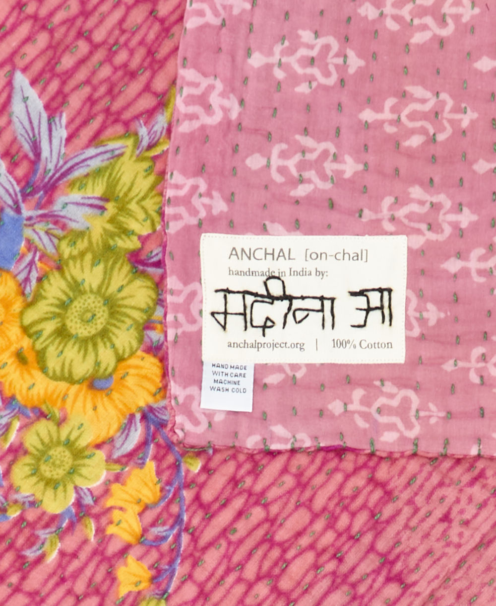 small kantha blanket with signature of the maker on the tag
