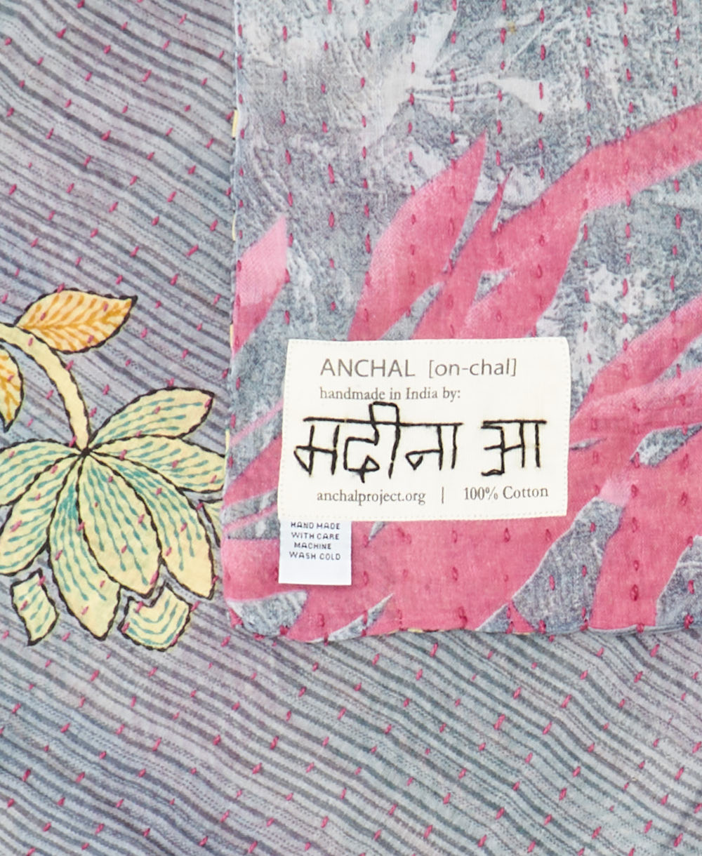 small kantha blanket with signature of the maker on the tag