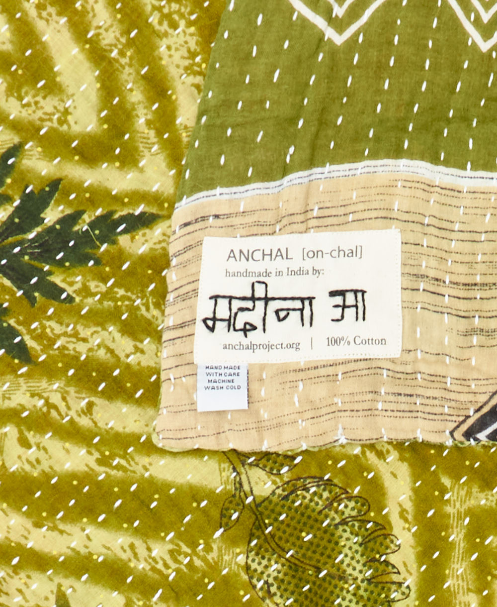 small kantha blanket with signature of the maker on the tag