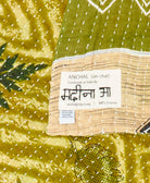 small kantha blanket with signature of the maker on the tag
