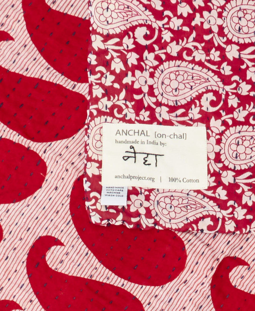 small kantha blanket with signature of the maker on the tag