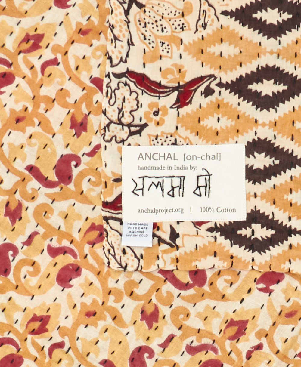 small kantha blanket with signature of the maker on the tag