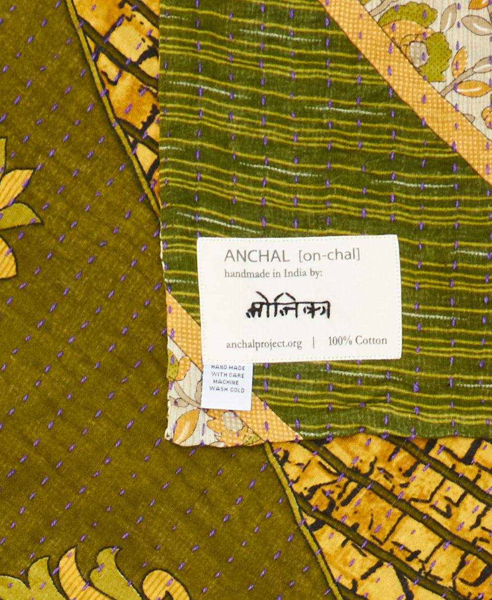 small kantha blanket with signature of the maker on the tag