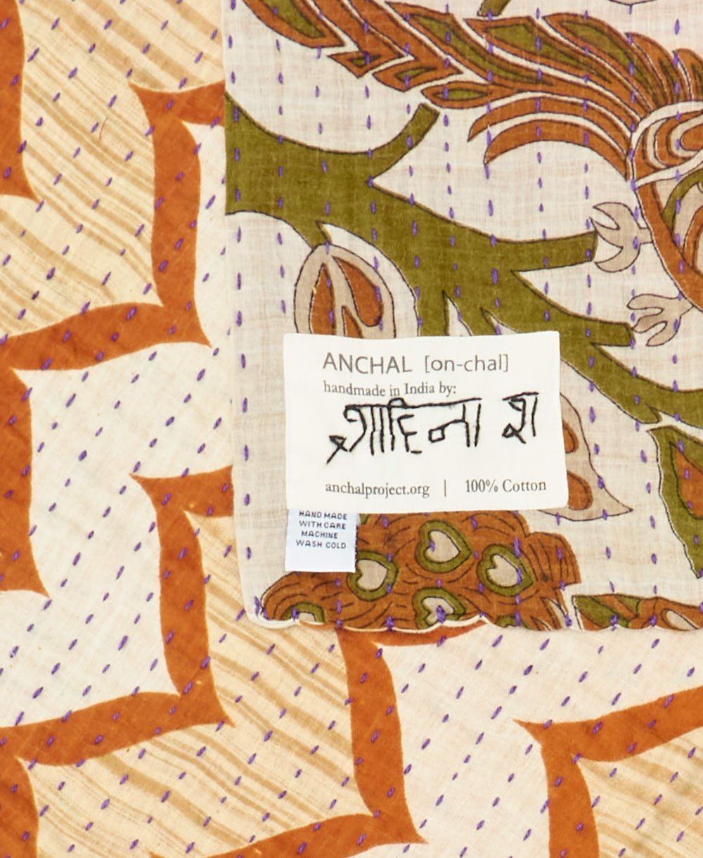 small kantha blanket with signature of the maker on the tag