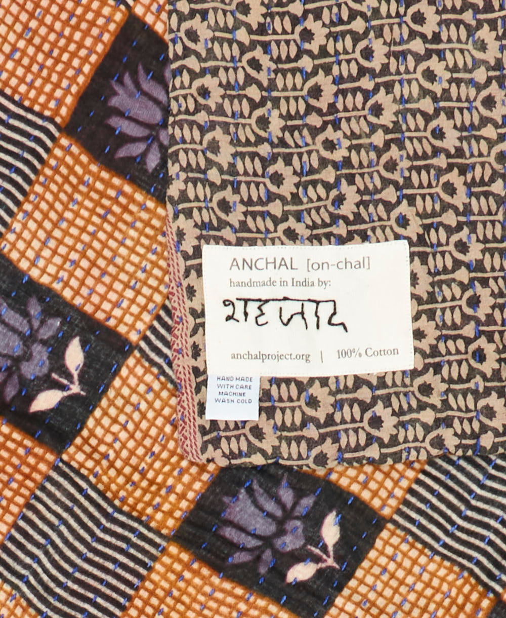 small kantha blanket with signature of the maker on the tag