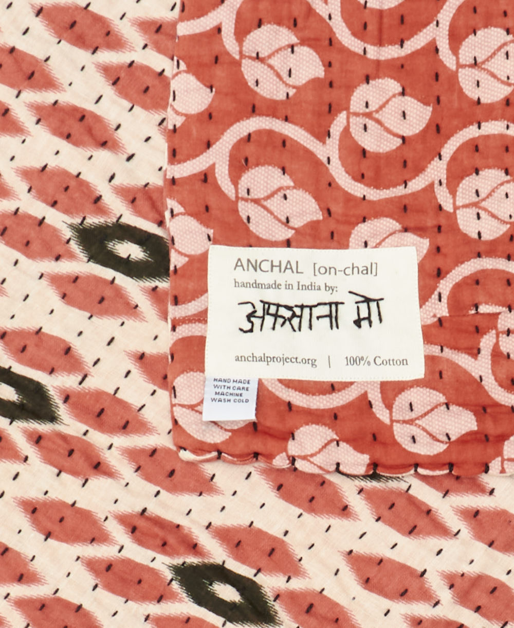 small kantha blanket with signature of the maker on the tag