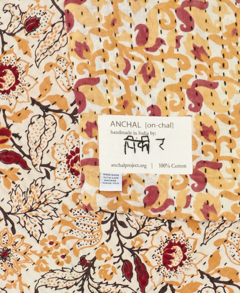 small kantha blanket with signature of the maker on the tag