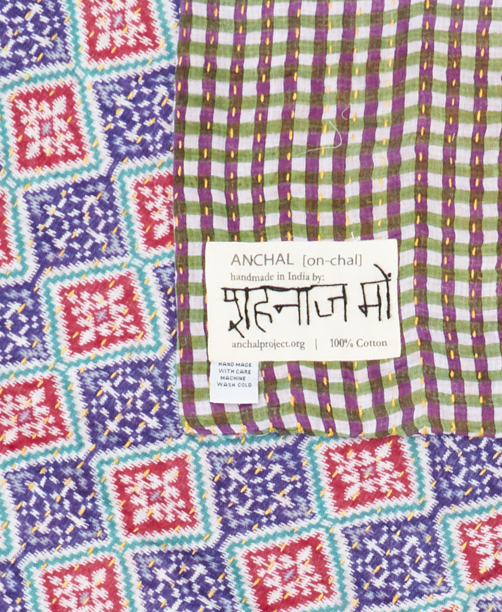 small kantha blanket with signature of the maker on the tag