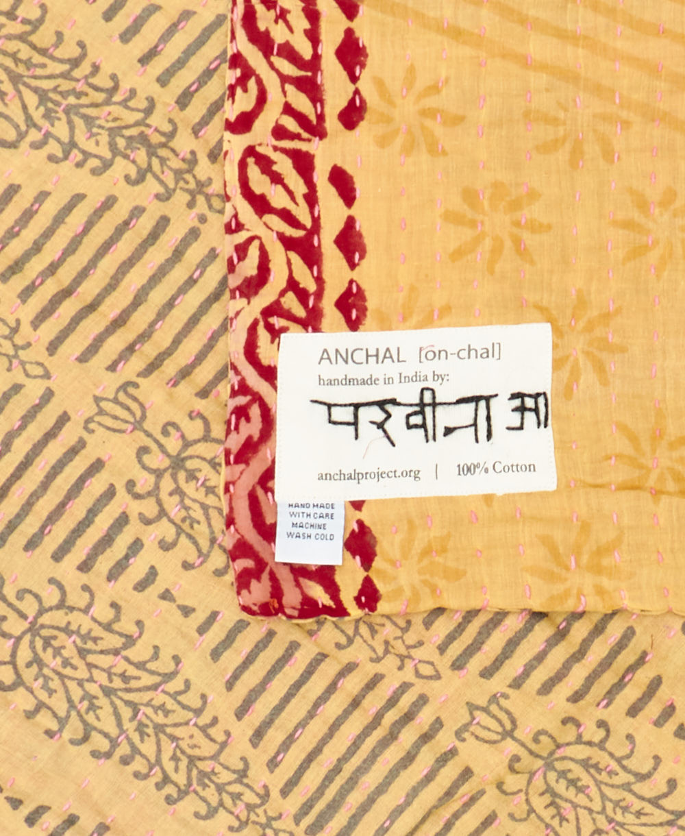 small kantha blanket with signature of the maker on the tag
