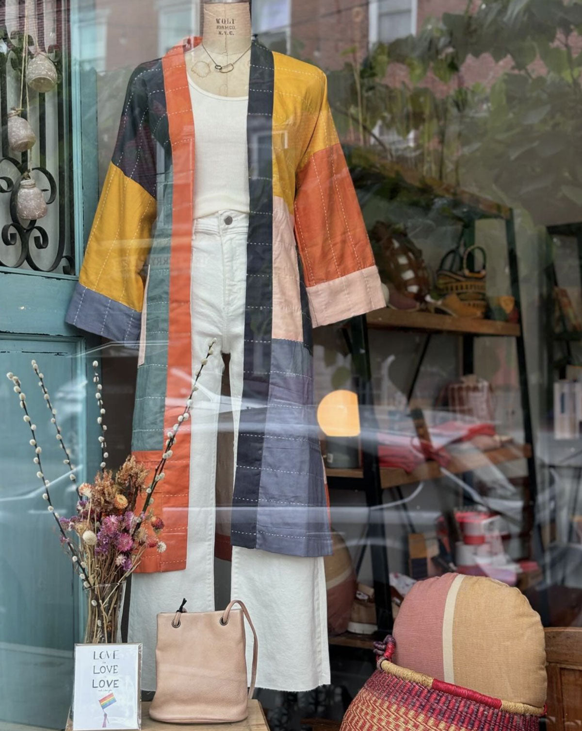 Anchal's colorblock cotton robe in boutique's storefront window on mannequin with white shirt & jeans