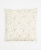 natural white throw pillow with black hand-stitched embroidery creating a repeating fan pattern