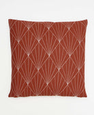 burnt orange throw pillow with white embroidery in a fan pattern made in India