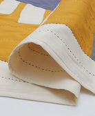 lightweight modern kantha quilt in white, yellow and slate blue with black and white kantha stitching