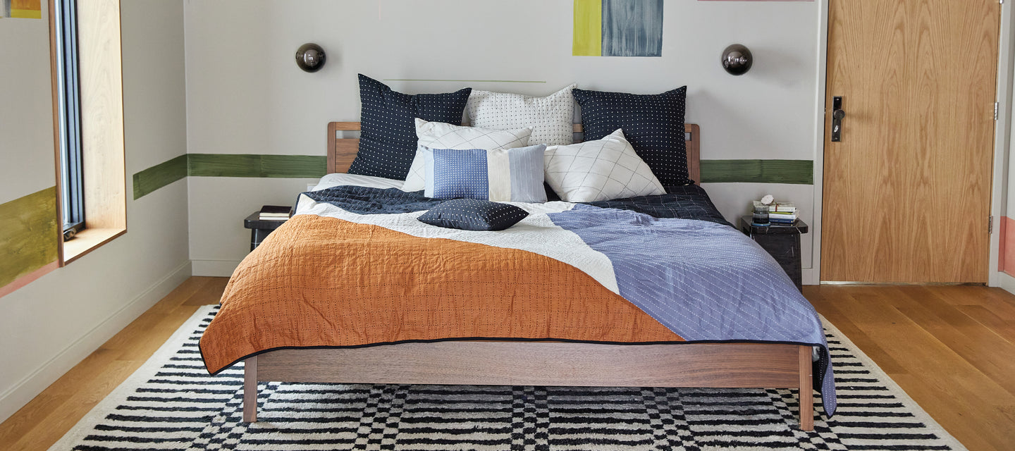 modern kantha quilt in graphic bold hues of camel, black and blues by Anchal