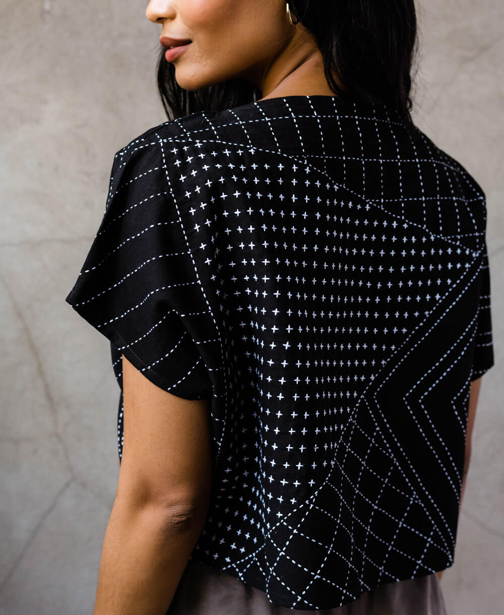 100% organic cotton twill black crop top with short sleeves featuring detailed white geometric kantha stitching patterns