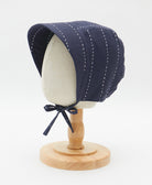 navy blue baby bonnet with foldable sun brim and chin ties made from organic cotton with white embroidery