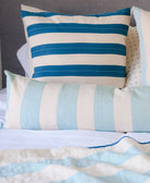 light blue vertically striped extra long lumbar pillow paired with horizontally stripe cobalt pillow