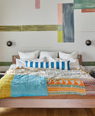 cobalt blue striped long lumbar bed pillow on modern boho bedframe