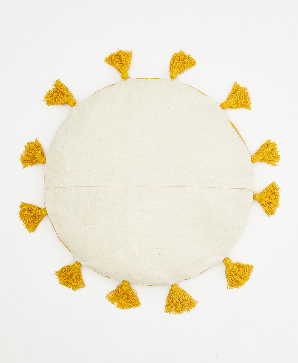 back of mustard yellow circle pillow with tassels and back zipper closure