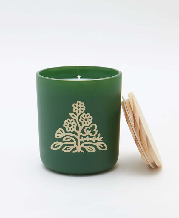 sandalwood green jar candle with coordinating wooden lid