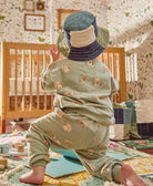 sustainable baby bucket hat in blue and green checkered design on toddler girl wearing puppy pajamas