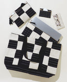 black and white checkered canvas tote bag with matching laptop sleeve and other small pouches