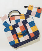 rainbow checkered tote bag with matching small pouches on a white background
