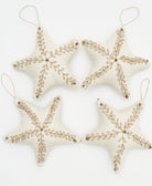 handmade fabric ornaments in star shapes with gold embroidery and gold beading