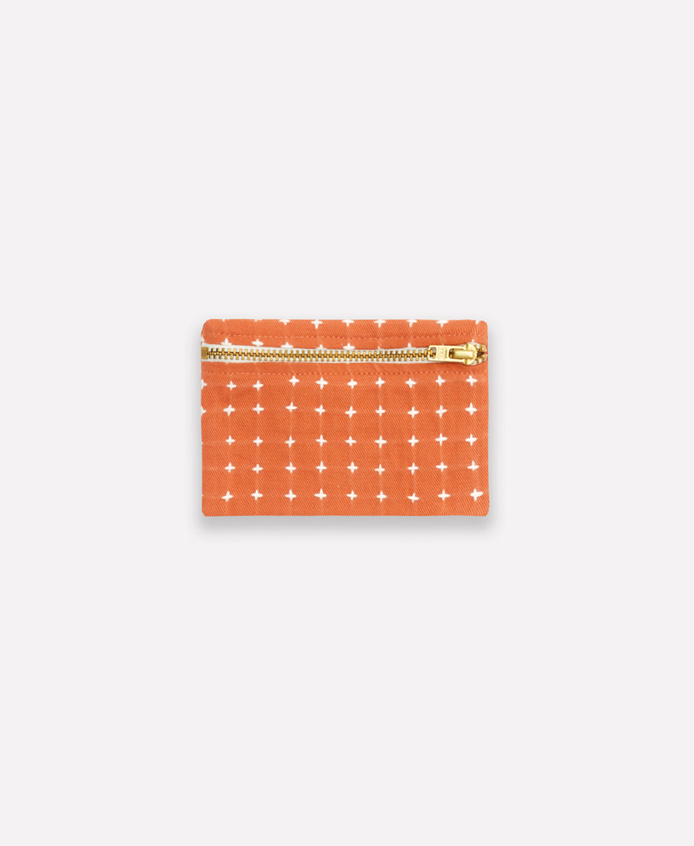Small pouch with star pattern and gold zipper on a white background