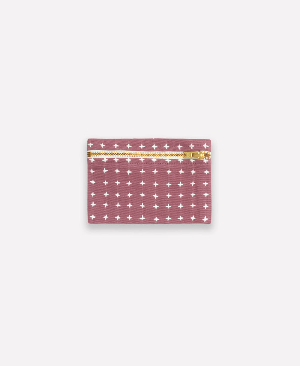 purple pouch with white cross pattern and gold zipper on a white background