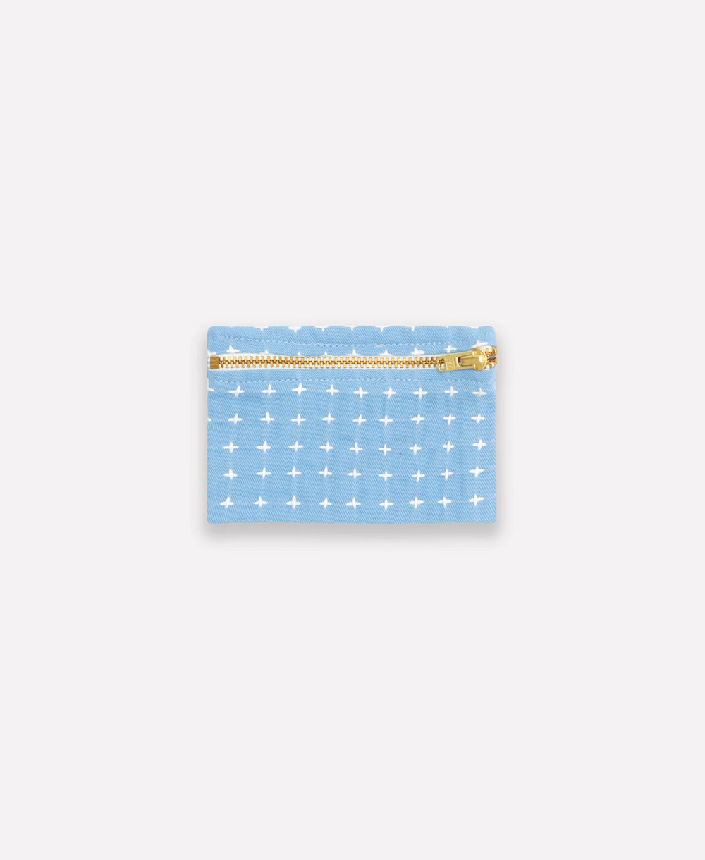 light blue coin purse with white embroidery pattern and gold toned zipper