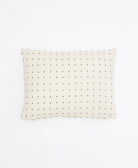 small pillow in ivory with black cross-stitch pattern handmade in India