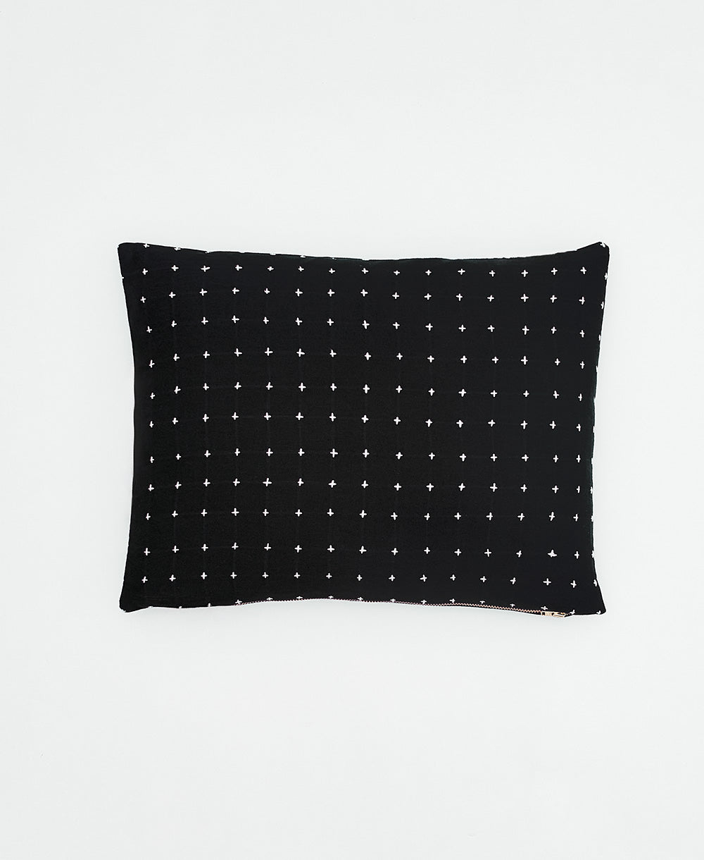 small throw pillow in charcoal black with white cross-stitch embroidery handmade in India