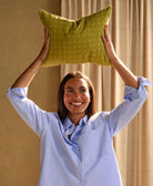 woman holding moss cross stitch small pillow 