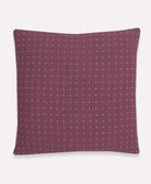 crushed berry throw pillow with white cross-stitch embroidery