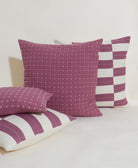 Set of purple and white patterned pillows on a light background