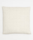 ivory throw pillow with black tiny cross-stitch embroidery on front