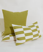 Two green patterned pillows on a white background