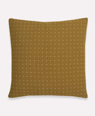 Brown pillow with white dot pattern on a white background