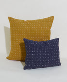 ochre yellow throw pillow with navy small pillow on white background