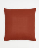 back of rust red cross-stitch throw pillow