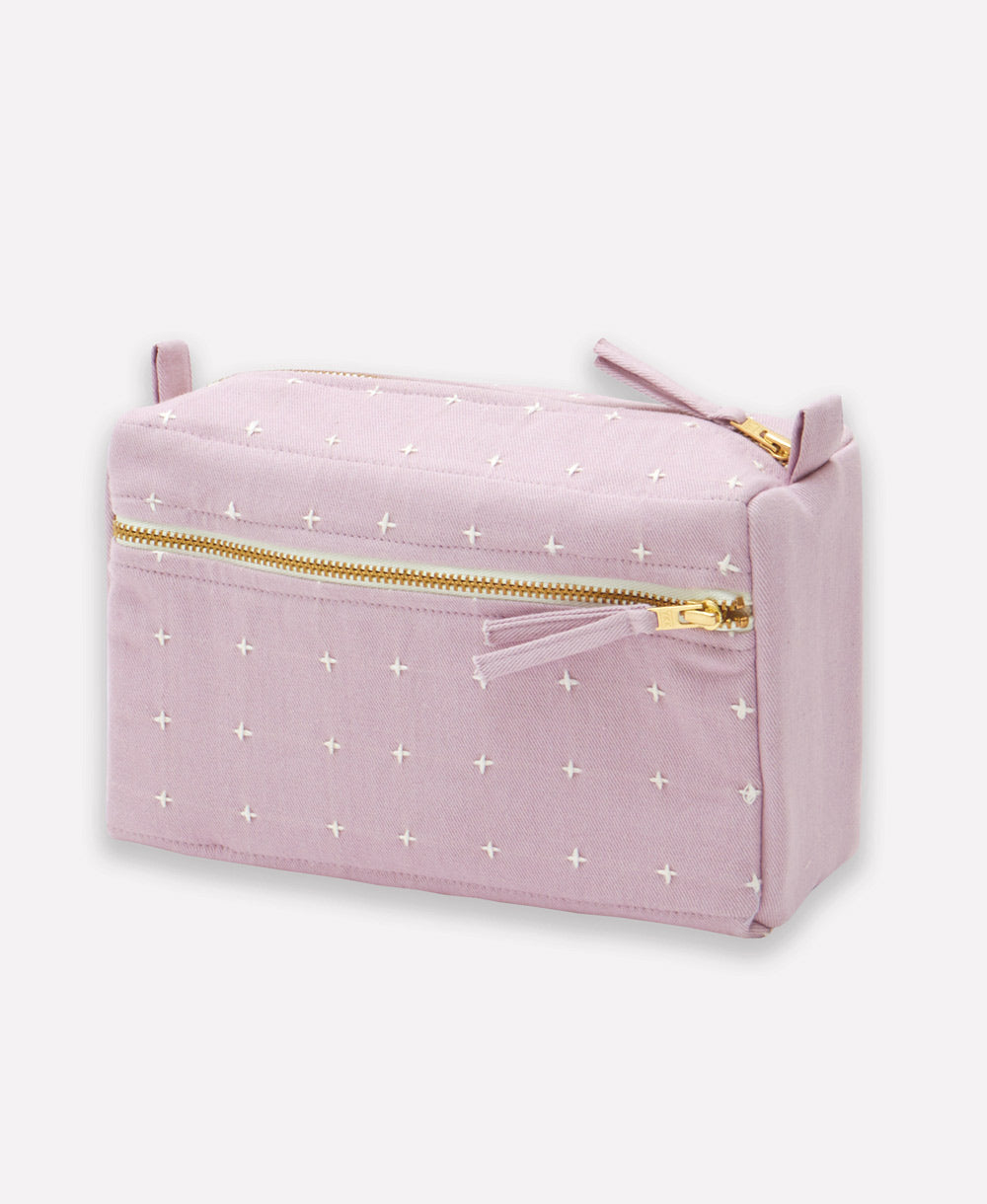 lilac purple small toiletry bag with white cross-stitch embroidery pattern with gold tone zipper closure