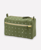 pine green toiletry bag with white cross-stitch pattern and gold zipper on a light gray background