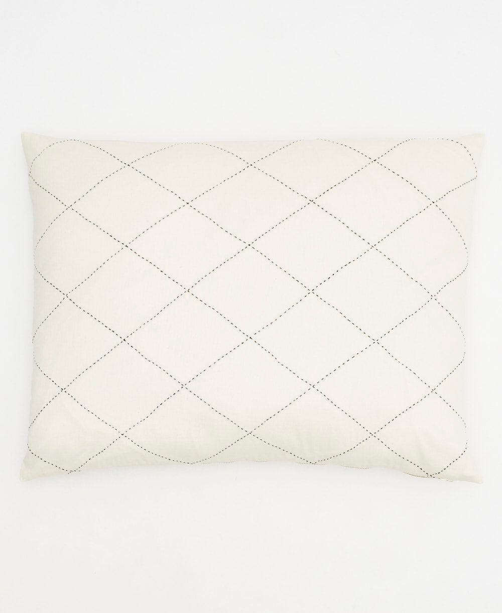 standard pillow sham in natural white with black embroidery forming a diamond stitch patten